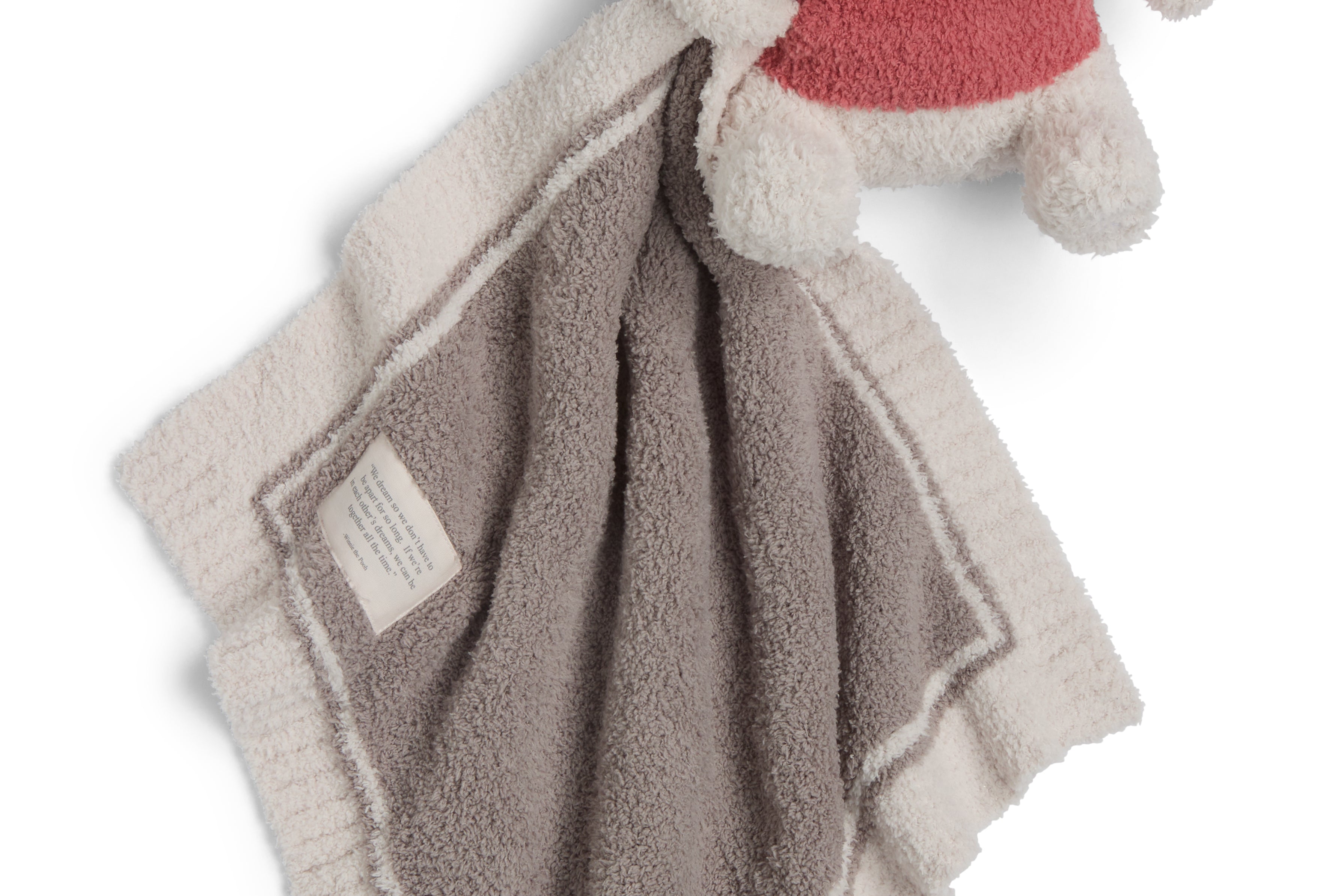 Barefoot Dreams Disney Blanket Buddie in Winnie the Pooh, plush Pooh in a red shirt on a tan lovey blanket