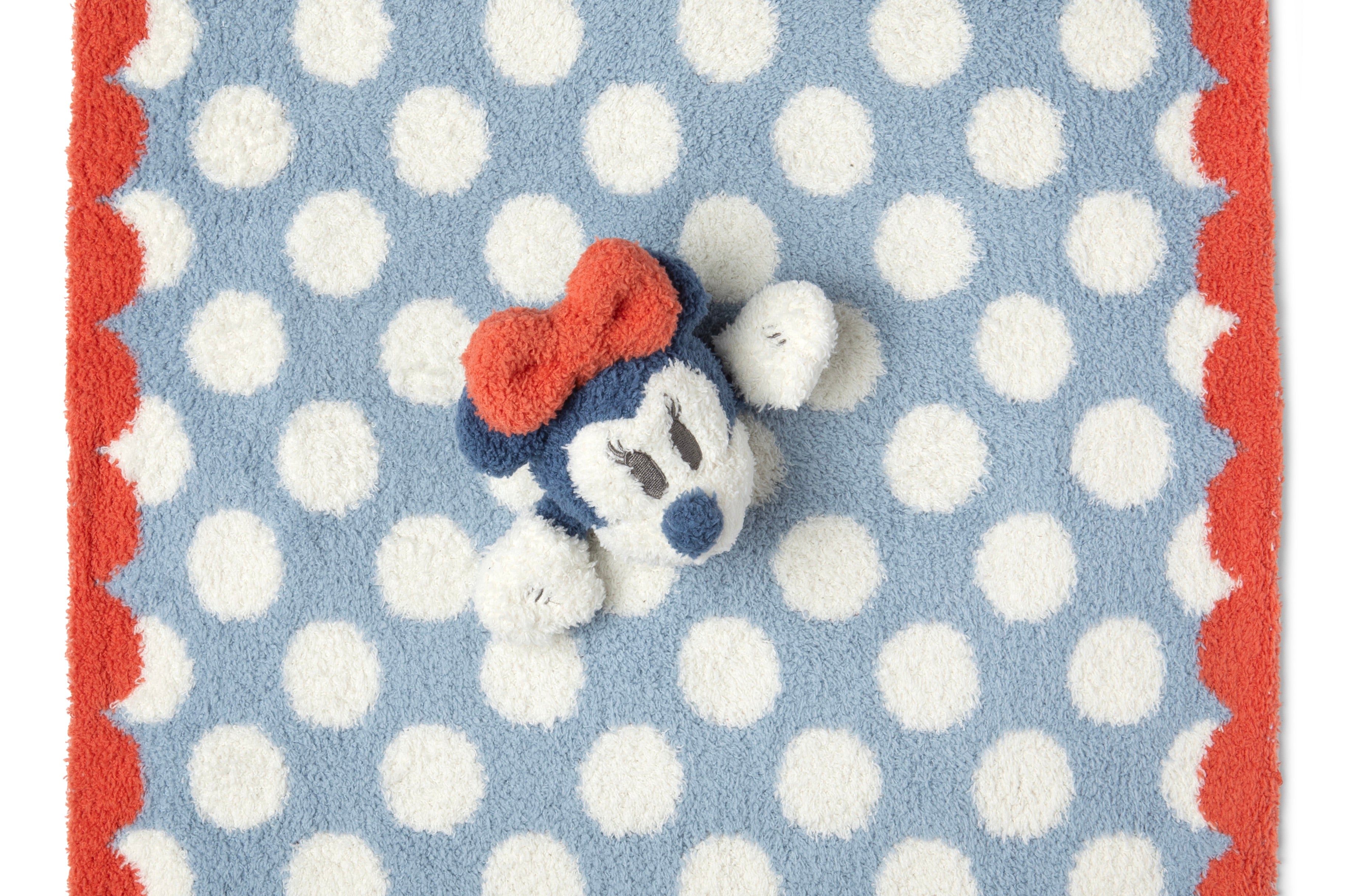 Barefoot Dreams Disney Lovey in Minnie Mouse laid flat showing the blue polka dot and red border