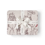 Barefoot Dreams Disney Stroller Blanket in Winnie the Pooh folded and tied with a Disney ribbon
