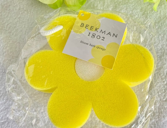 Beekman 1802 Bloom Bath Sponge, a bright yellow flower-shaped sponge with a Beekman tag