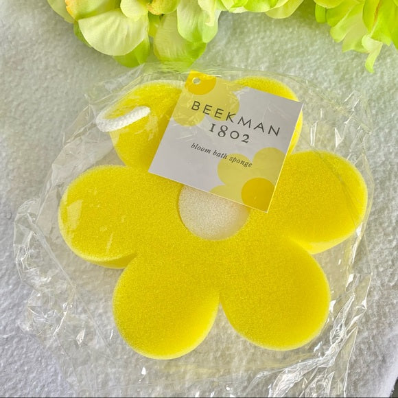 Beekman 1802 Bloom Bath Sponge, a bright yellow flower-shaped sponge with a Beekman tag