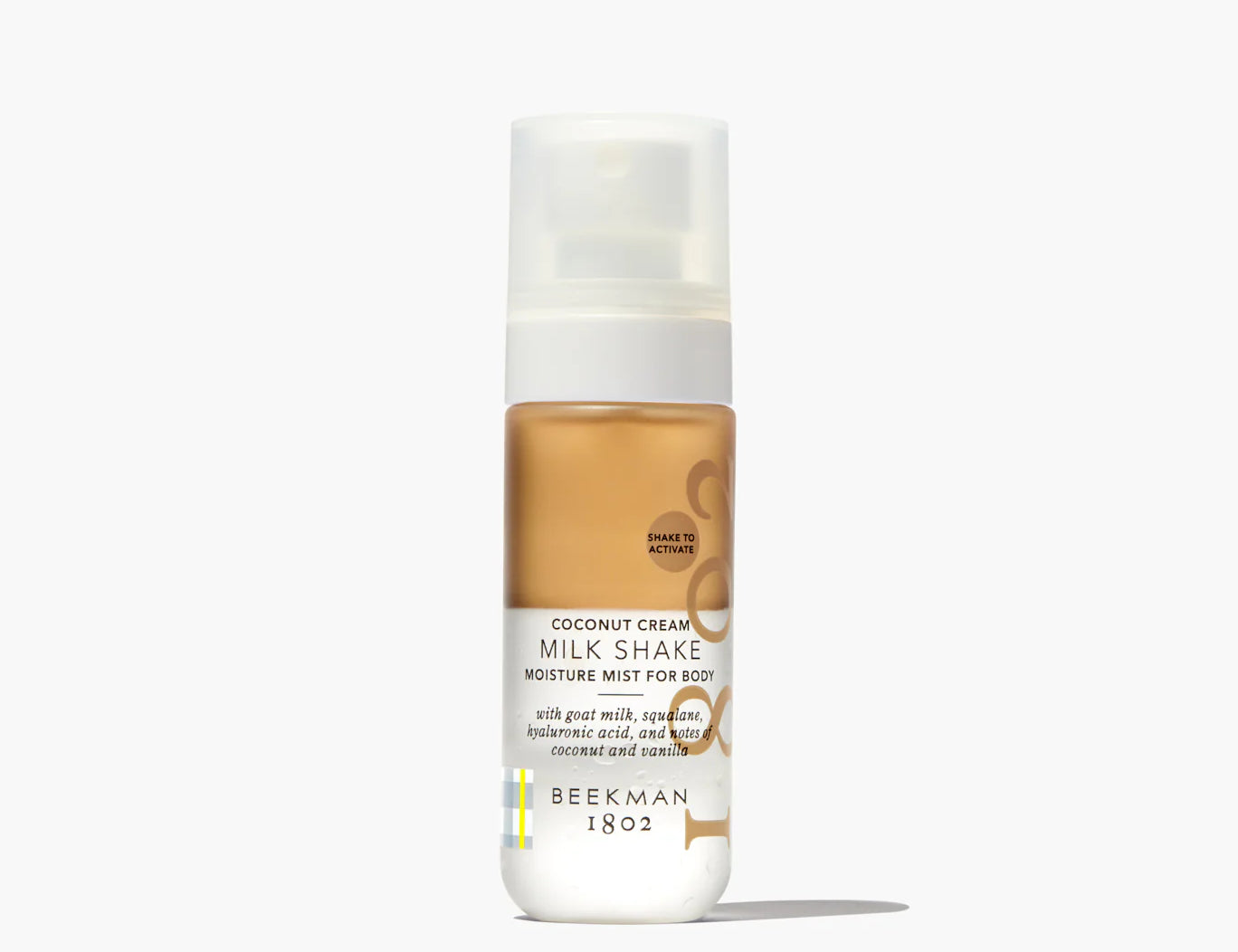 Beekman 1802 Milk Shake Moisture Mist in Coconut Cream, a bi-phase body mist in a clear spray bottle