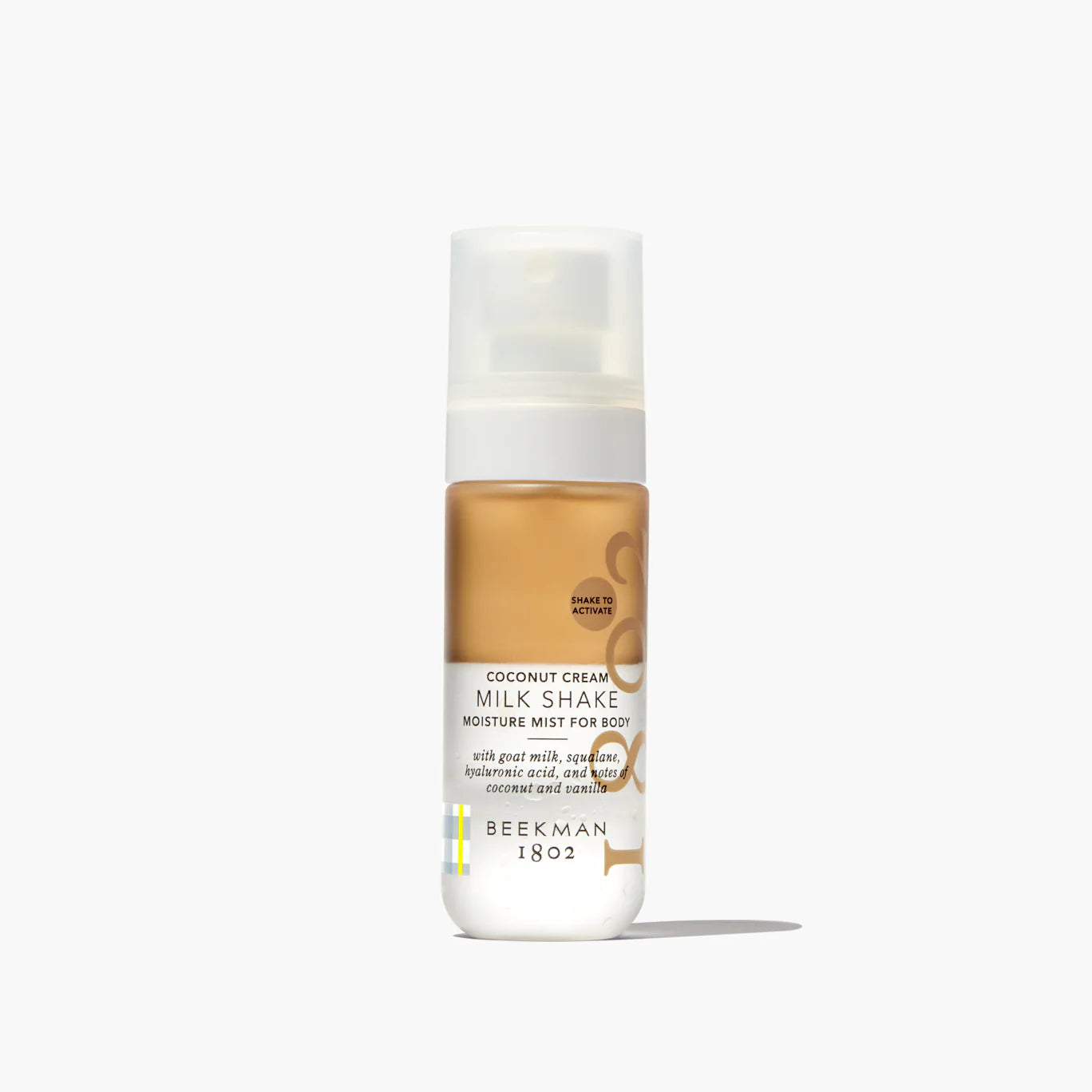 Beekman 1802 Milk Shake Moisture Mist in Coconut Cream, a bi-phase body mist in a clear spray bottle