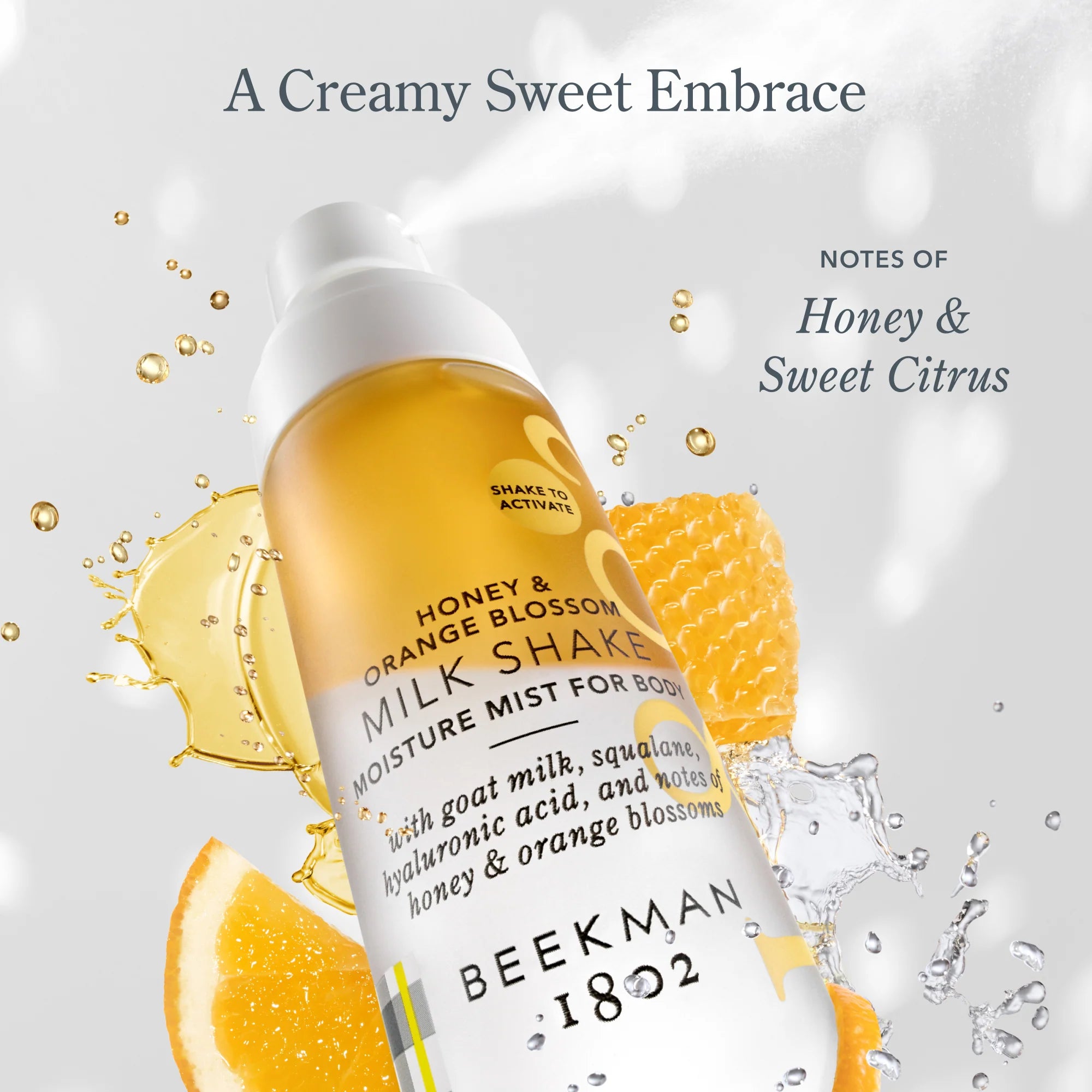 Beekman 1802 Milk Shake Moisture Mist in Honey & Orange Blossom with orange slices and honeycomb