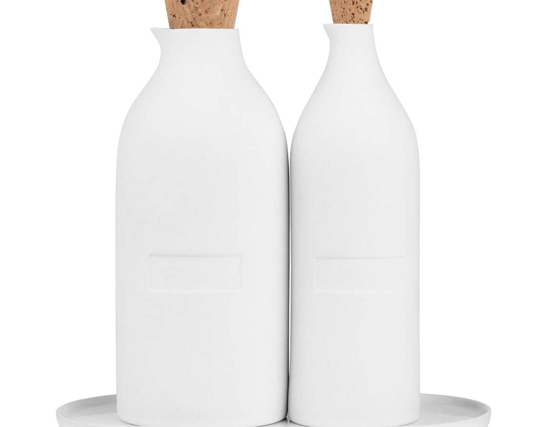 Blomus Bon Appetit Porcelain Cruet Bottles, two white oil and vinegar bottles with cork stoppers on a white tray