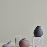Blomus Nona 3 Vase Set displayed on stone blocks against a gray wall