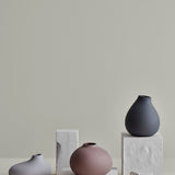 Blomus Nona 3 Vase Set displayed on stone blocks against a gray wall