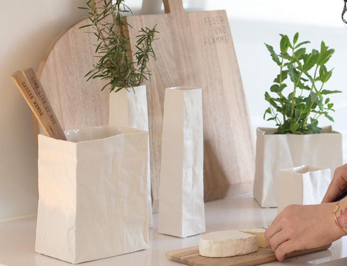 Blomus Porcelain Bag Vases in several sizes holding herbs on a kitchen counter