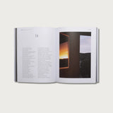 Book of Proverbs KJV hardcover open to chapter 14 with a sunset photo