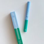 Botanica Flameless Lighter in Earth, a sky blue and green USB lighter beside its box