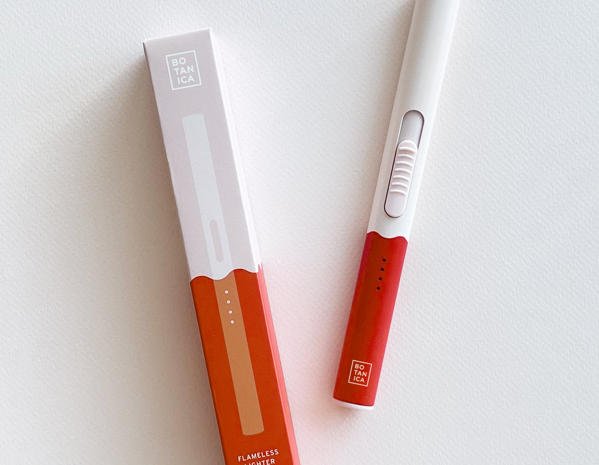 Botanica Flameless Lighter in Poppy, a white and red USB lighter beside its box