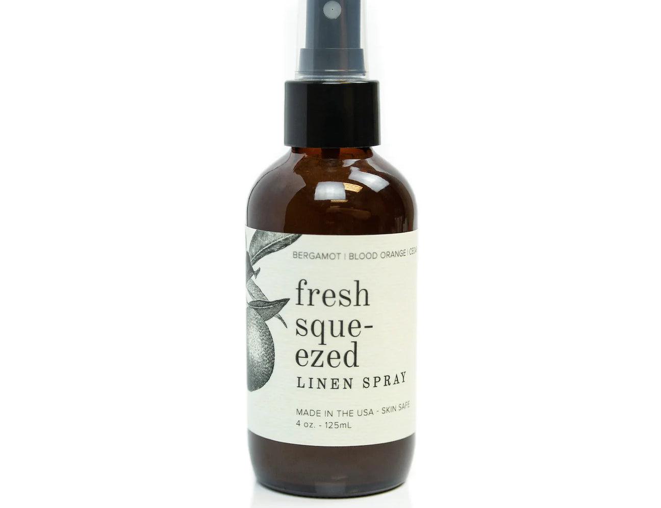 Broken Top Brands Fresh Squeezed Linen Spray in an amber glass bottle with a black spray top