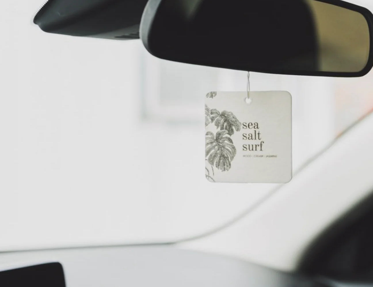 Broken Top Brands Sea Salt Surf Car Freshener hanging from a rearview mirror