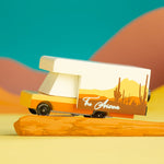 Candylab Toys Arizona Wooden RV toy camper on an orange desert-styled backdrop with teal sky