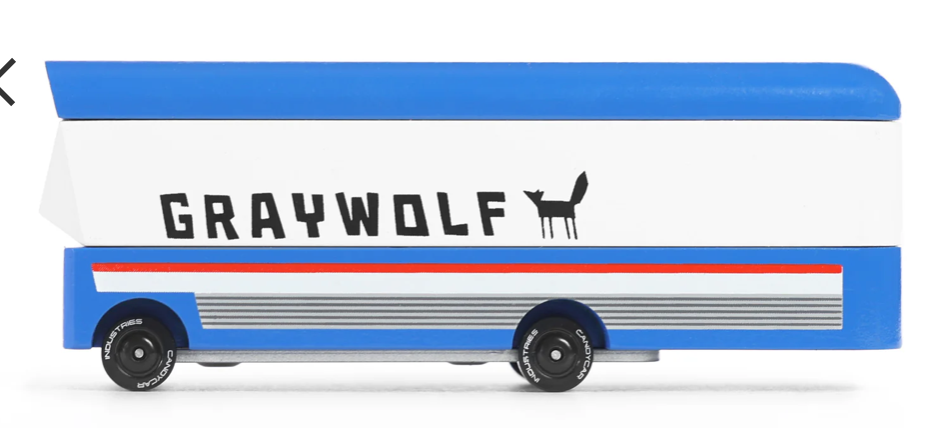 Candylab Toys Graywolf Bus, a white wooden toy bus with blue and red stripes and a wolf logo, close-up side view