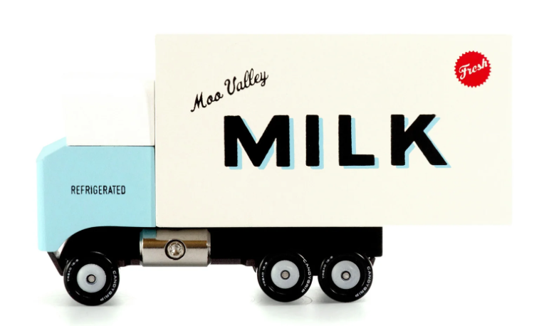 Candylab Toys Milk Truck, a cream wooden Moo Valley Milk delivery truck, close-up side view