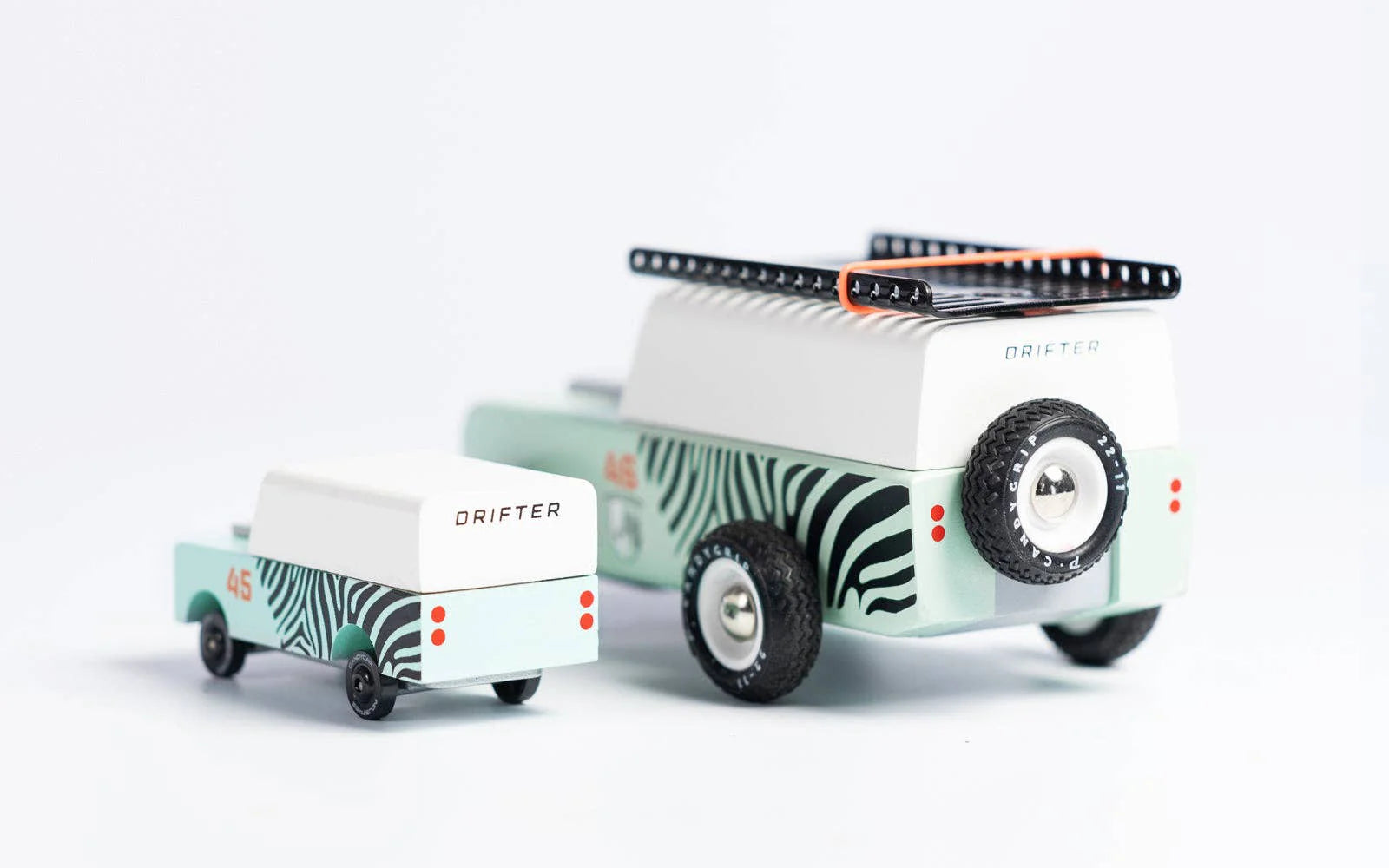Candylab Toys Mini Zebra Drifter shown beside the full-size Zebra Drifter for scale
