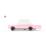 Candylab Toys Pink Wooden Sedan, a bubblegum pink wooden toy car with a white roof, side view