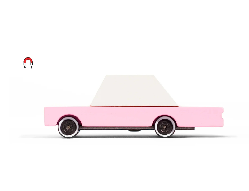 Candylab Toys Pink Wooden Sedan, a bubblegum pink wooden toy car with a white roof, side view