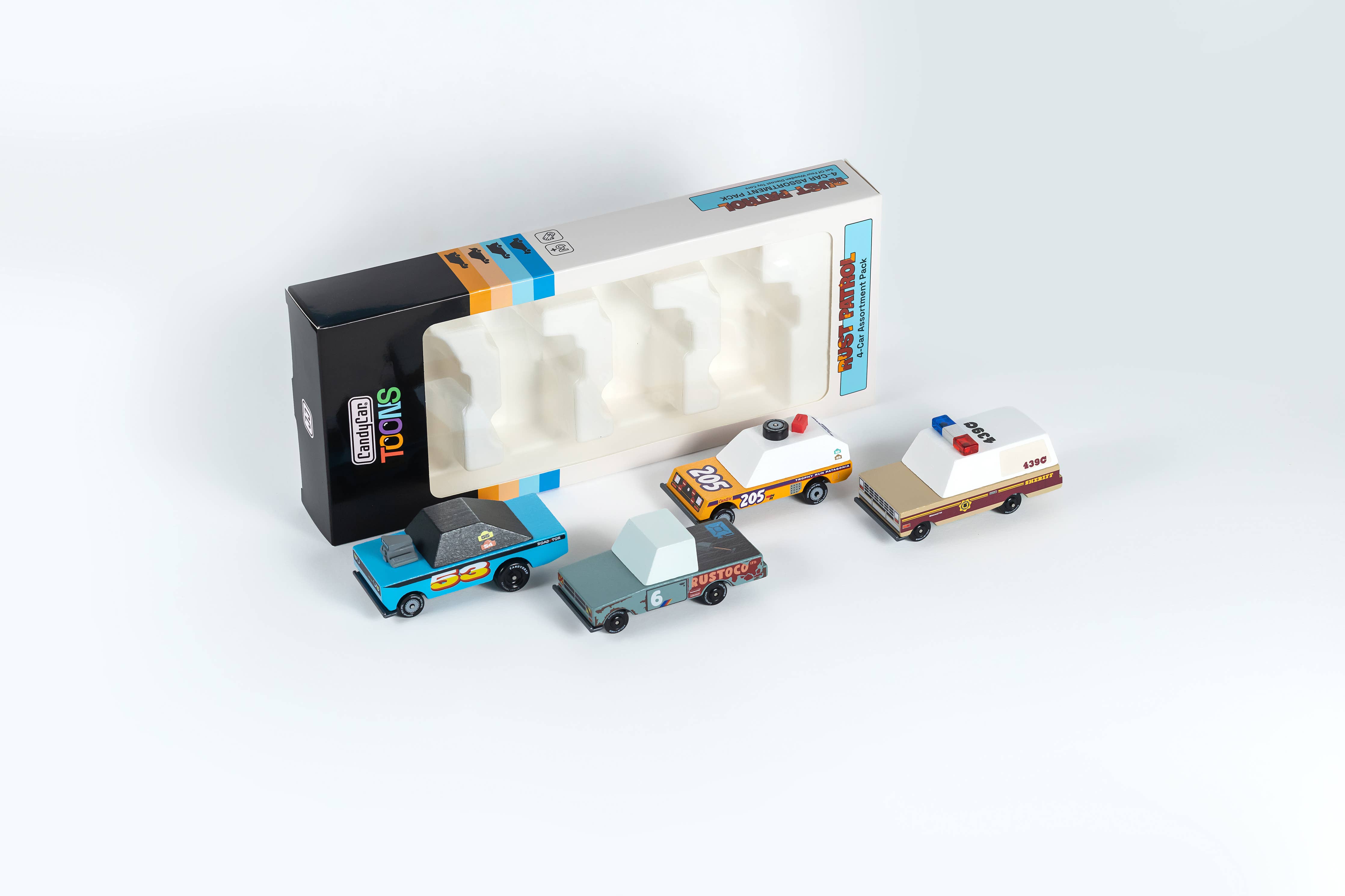 Candylab Toys Rust Patrol TOONS 4-Pack vehicles beside their open retail box
