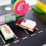 Candylab Toys Sheriff Truck on a toy road scene beside a donut shop and food trucks