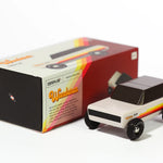 Candylab Toys Wanderer Toy Truck beside its retro striped retail box