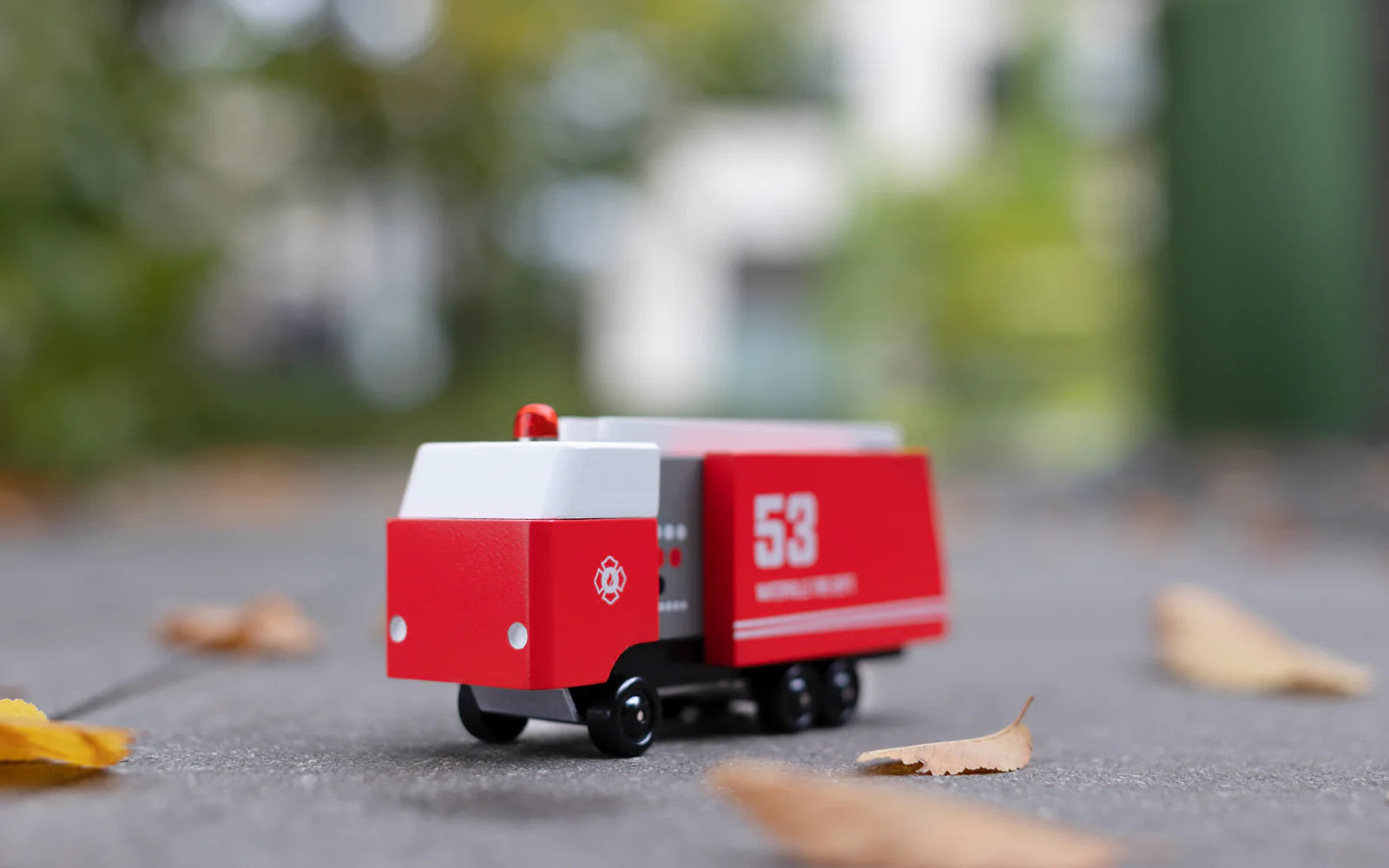 Candylab Toys Wooden Fire Truck 53 on pavement outdoors