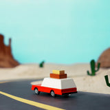 Candylab Toys Wooden Luggage Wagon on a toy desert road with cacti