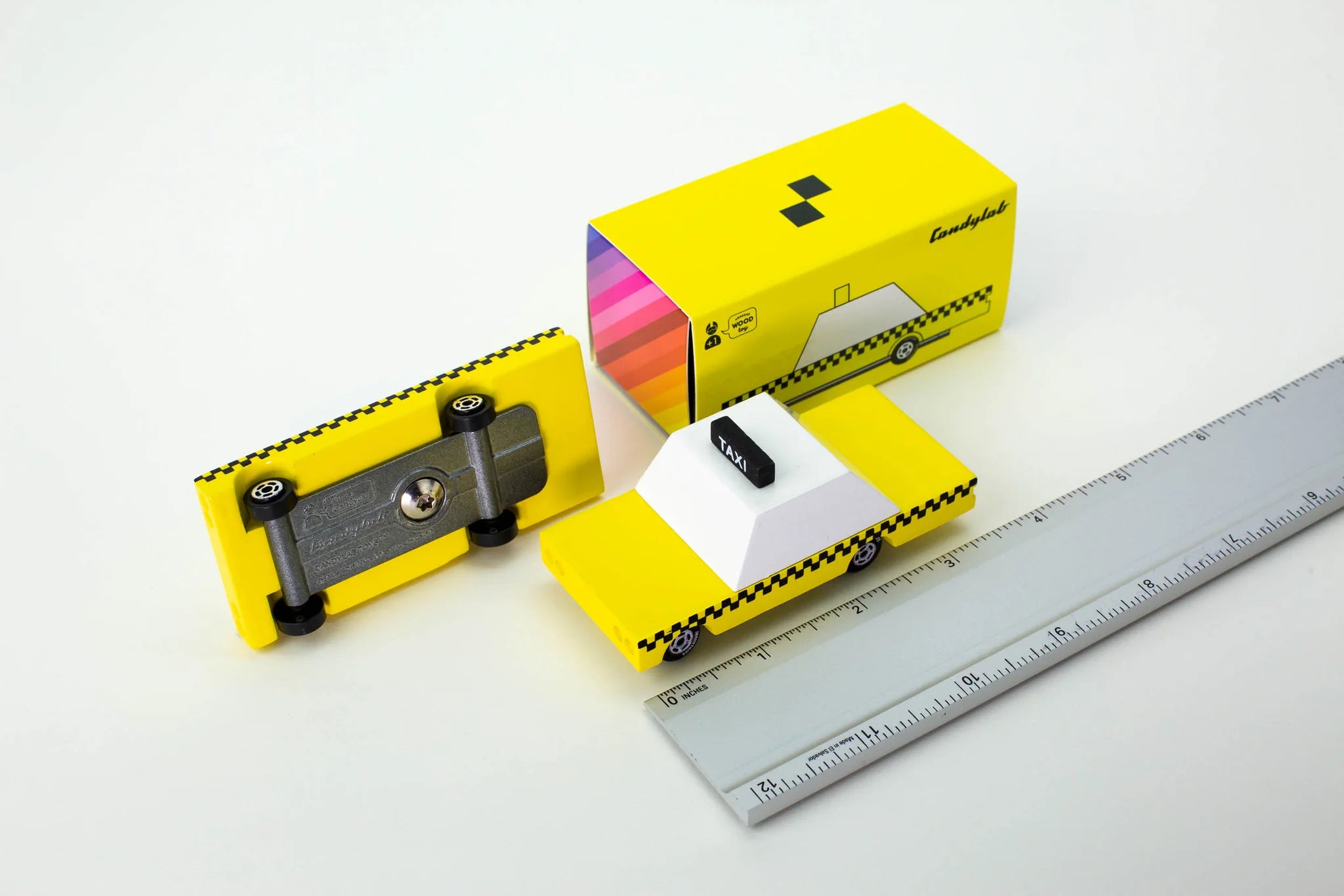 Candylab Toys Yellow Wooden Taxi with its retail box and a ruler showing its size