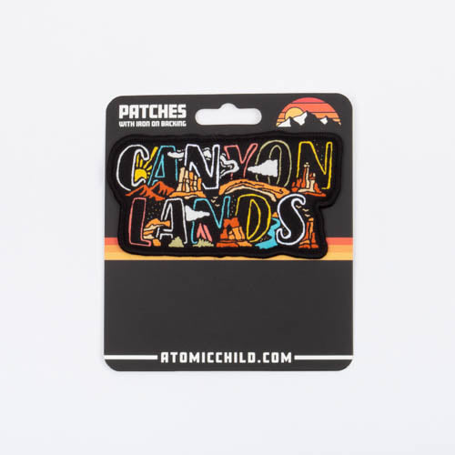 The Canyonlands nameplate patch on its Atomic Child backer card, marked patches, iron on or sew on.