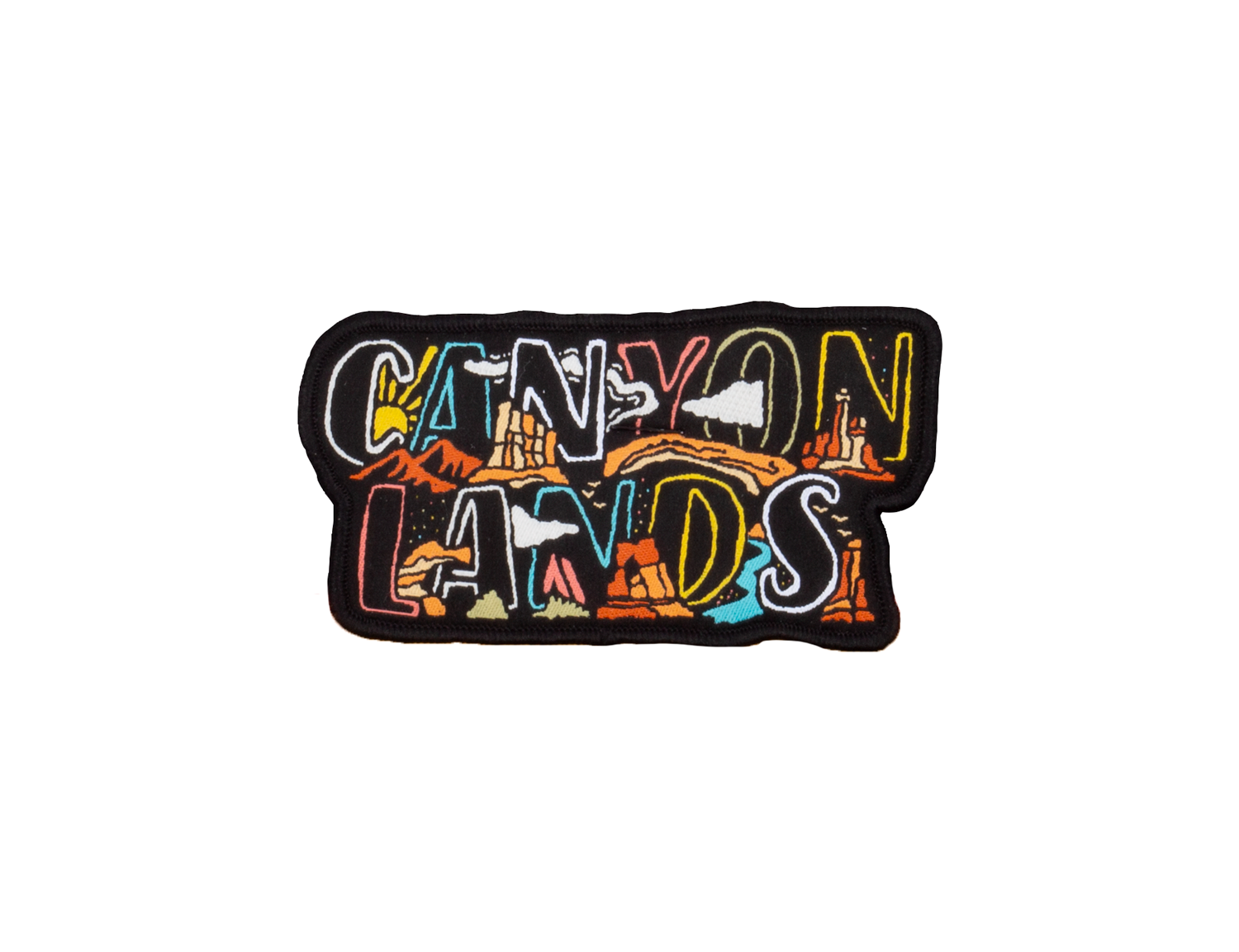 Canyonlands nameplate patch, CANYON LANDS embroidered in two rows of block letters with canyon scenery inside each letter, black merrowed border.