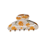 Classic claw clip in Apricot Floral, a glossy cream hair claw clip with a yellow and apricot floral print, on a white background.