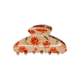 Classic claw clip in Brushed Sand Floral, a glossy light beige hair claw clip with an orange and red floral print, on a white background.