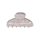 Classic claw clip in Pearl, a glossy translucent marbled white hair claw clip, on a white background.