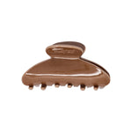 Classic claw clip in Roman Clay, a glossy warm brown hair claw clip with a small embossed logo on the top loop, on a white background.