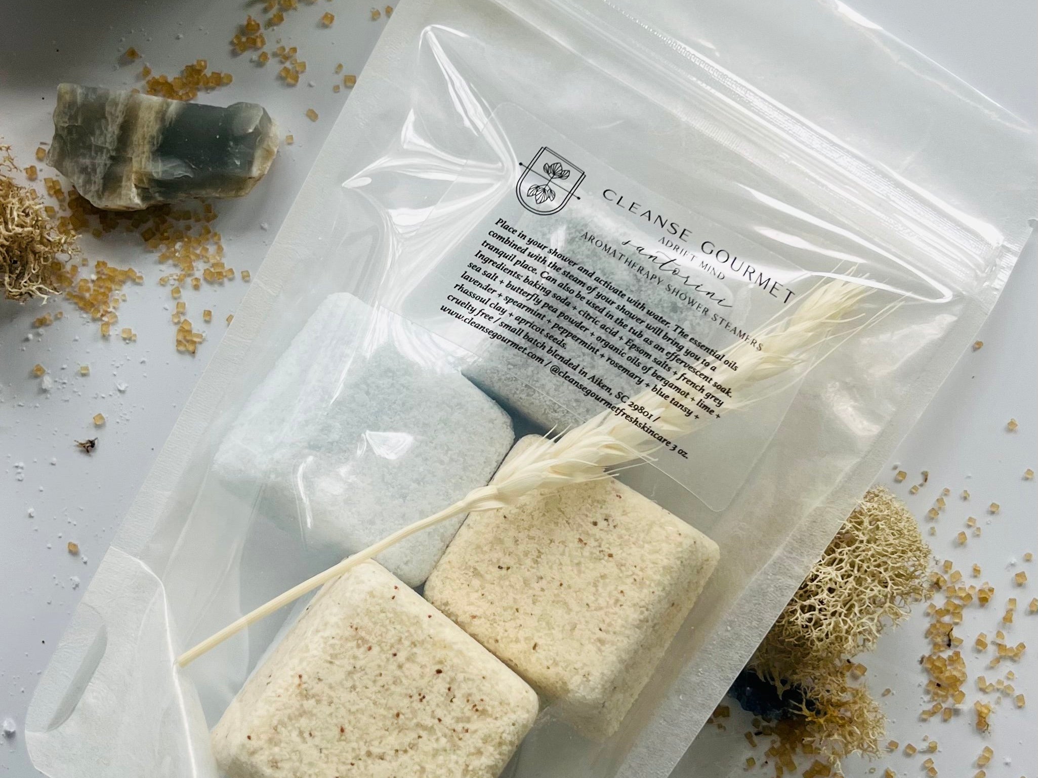 Cleanse Gourmet Santorini Botanical Shower Steamers, blue and cream cubes in a clear pouch