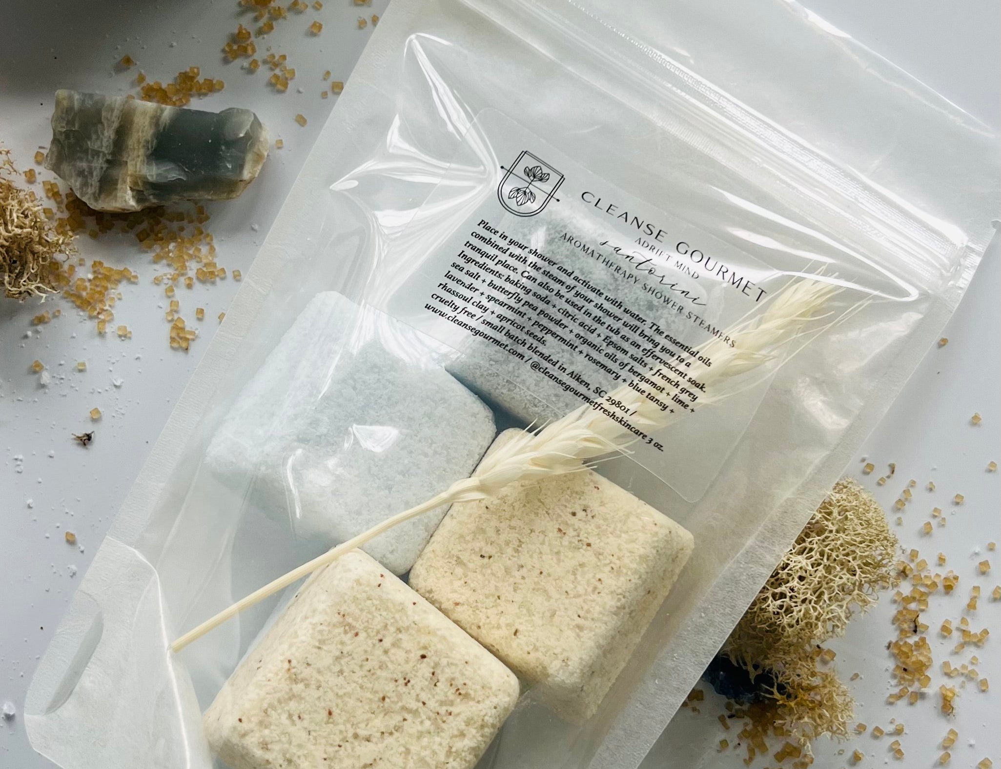 Cleanse Gourmet Santorini Botanical Shower Steamers, blue and cream cubes in a clear pouch