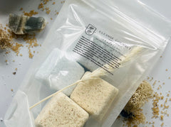 Cleanse Gourmet Santorini Botanical Shower Steamers, blue and cream cubes in a clear pouch