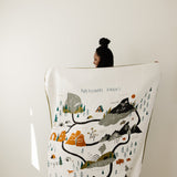 Clementine Kids Large Reversible National Parks Throw Blanket held up showing the illustrated parks map