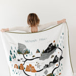 Child holding up the Clementine Kids Reversible National Parks Quilt