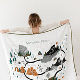 Child holding up the Clementine Kids Reversible National Parks Quilt