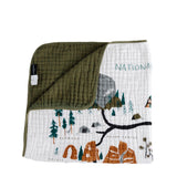 Clementine Kids Reversible National Parks Quilt with an illustrated parks map and an olive green reverse