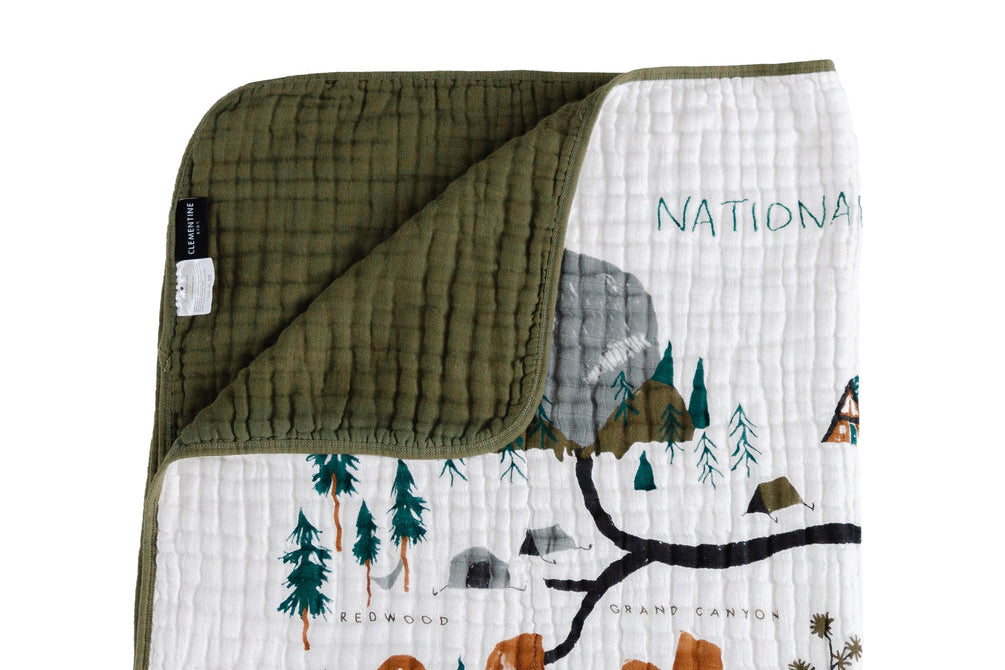 Clementine Kids Reversible National Parks Quilt with an illustrated parks map and an olive green reverse