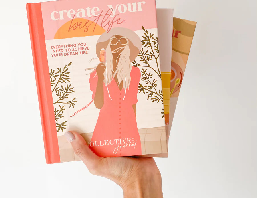 Hand holding the Collective Hub Create Your Best Life Journal showing its colorful page edges