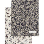 Colored Organics 2-Pack Organic Baby Burp Cloths in Poppy and Chicory Floral, one cream floral cloth and one navy cloth with a dense white floral print
