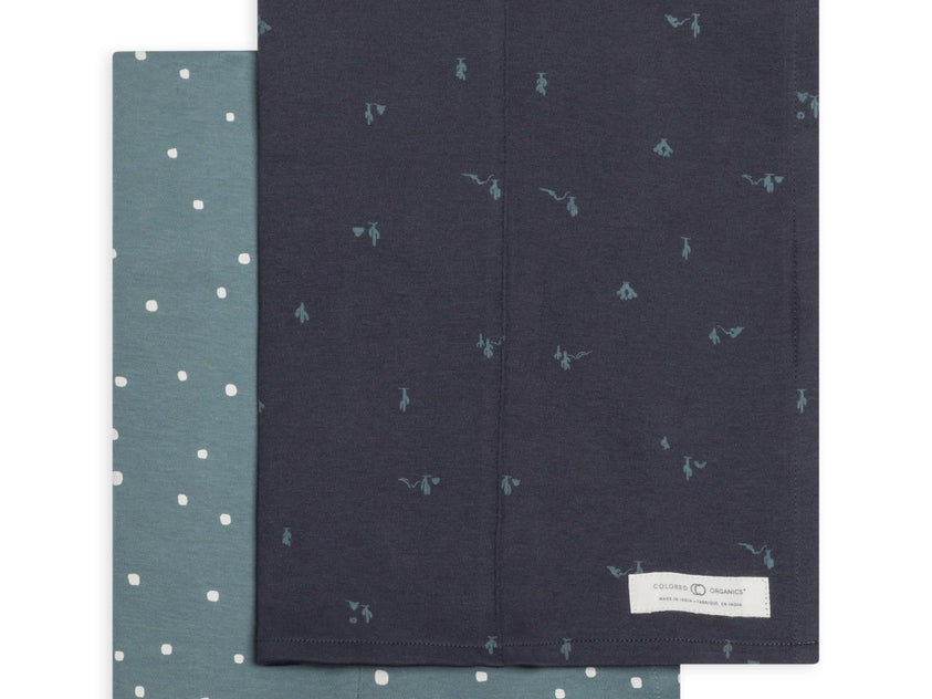 Colored Organics 2-Pack Organic Baby Burp Cloths in Square Dot and Cactus Navy, one sage green polka dot cloth and one navy cloth with a small cactus print