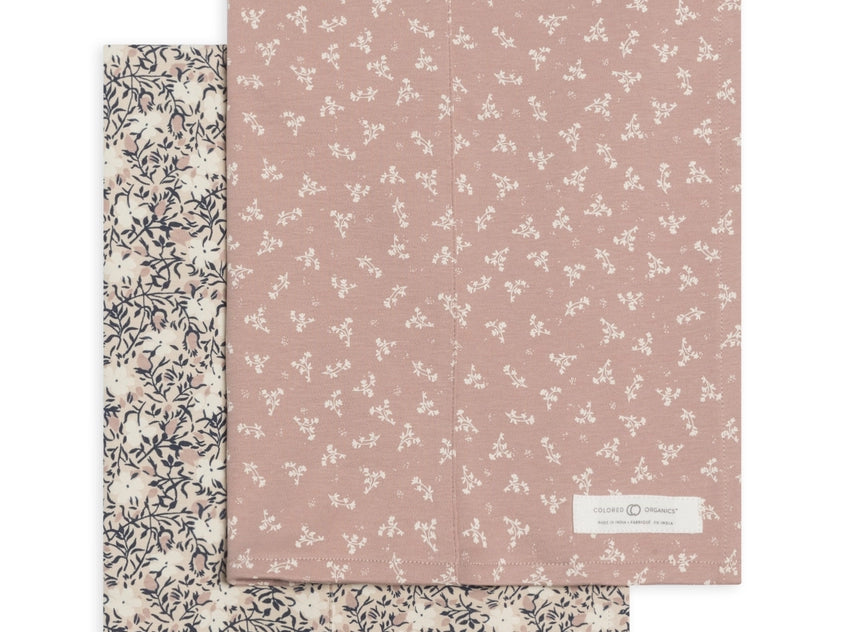 Colored Organics 2-Pack Organic Baby Burp Cloths in Verbena and Wild Floral, one cream floral cloth and one dusty rose cloth with a small white sprig print