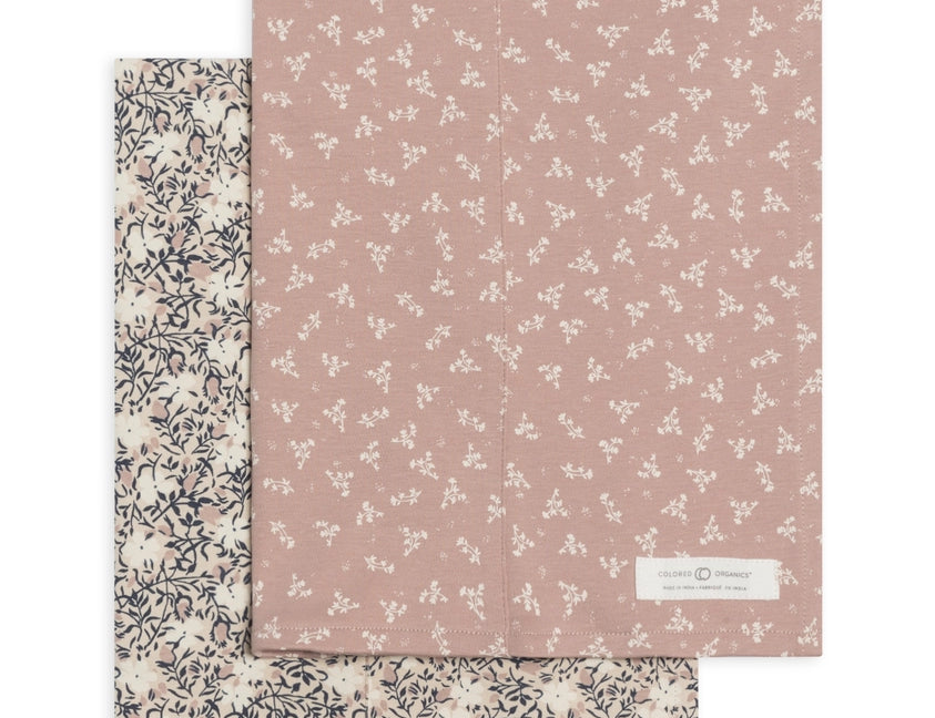 Colored Organics 2-Pack Organic Baby Burp Cloths in Verbena and Wild Floral, one cream floral cloth and one dusty rose cloth with a small white sprig print