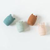 Colored Organics Animal Bath Toys, top view of the teal bear, sage owl, terracotta cat and blush bunny silicone toys