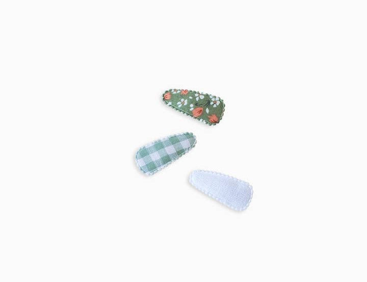 Colored Organics Mini Baby Hair Clips 3-Pack laid out: strawberry print, green gingham and white eyelet
